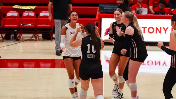 JuJu Martin celebrating a point with teammates.