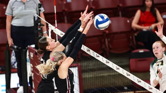 Emma Duffield and Makena Parthen combining for a block.