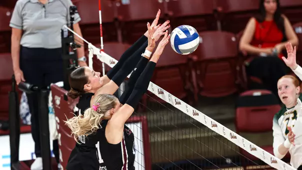 Emma Duffield and Makena Parthen combining for a block.