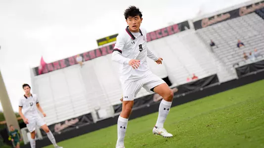 Michiharu Tanakashi running down the pitch watching the ball.