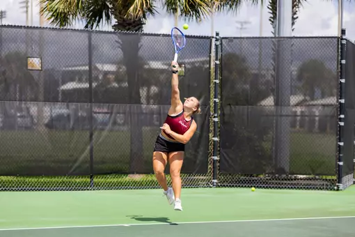 Marra Bruce reaching up to hit the tennis ball