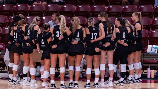 Charleston volleyball team huddle during a timeout.