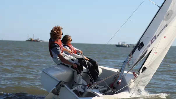 Two sailors in a dinghy boat.