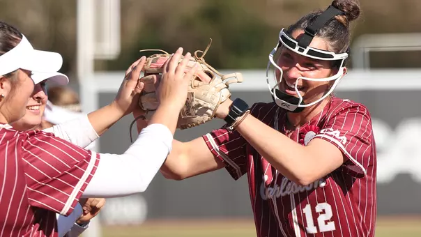 Mackenzie Mathis high-fiving her teammates during starting lineups