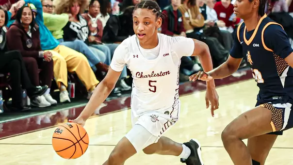 Taryn Barbot dribbles by defender