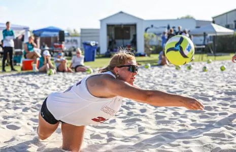 Ella Duffner dives for the ball in the sand