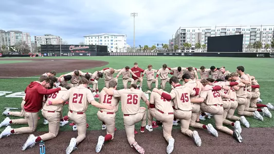 Baseball team huddle before a game.