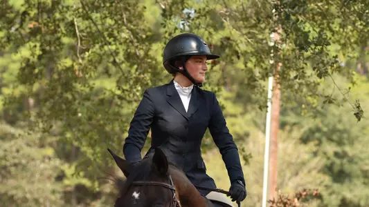 Lily Kress-Davies riding a horse during competition.