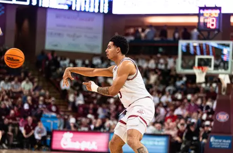 Martin Kalu passes the basketball