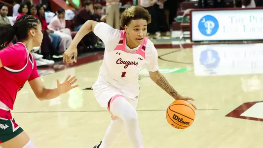 Leah Philpotts drives by defender