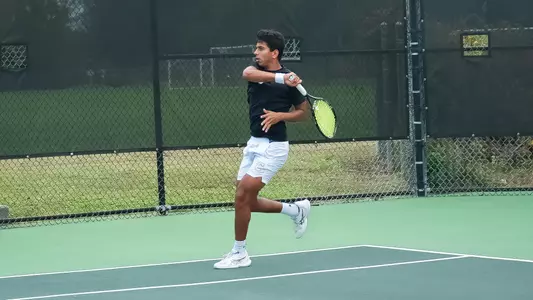 Ram Mude hits ball over net