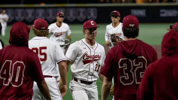 Austin Wiegandt giving high-fives March 20, 2026 against UNCW.