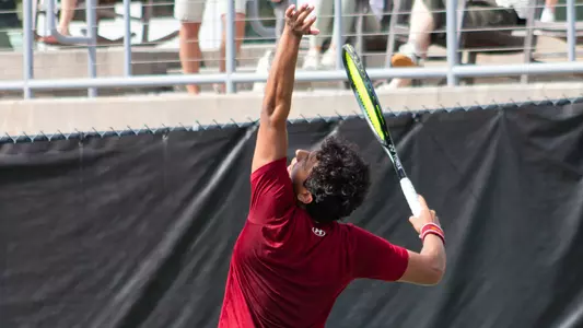 Dani Farran serves tennis ball