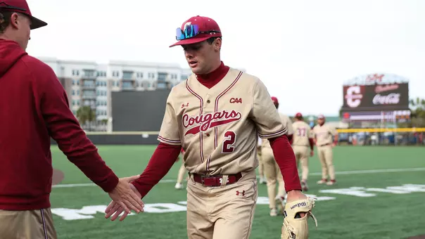 Reece Holbrook giving a high five to a teammate.