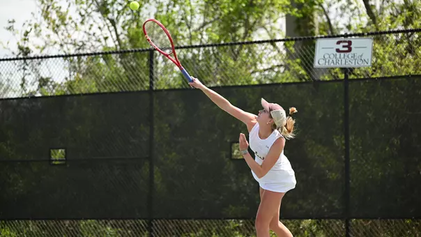 Saige Severance serves tennis ball