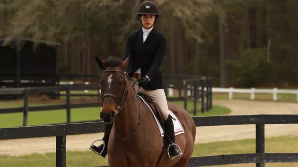 Maggie Armes riding a horse at practice.