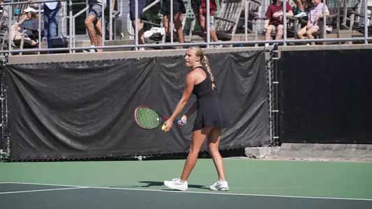 Riley Trinkle serves tennis ball