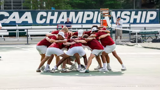 Men's Tennis team huddles at CAA Championship