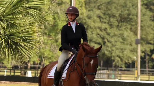 Lainie Rubin riding a horse at practice.
