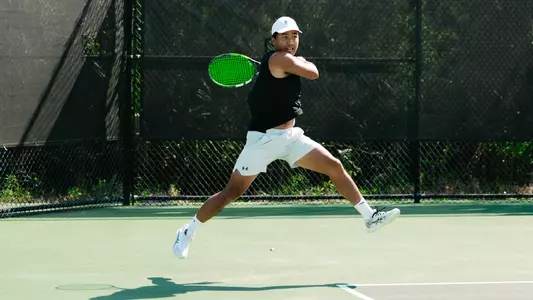 Eddie Vo hits tennis ball