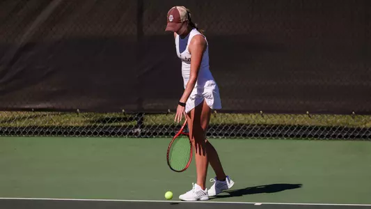 Saige Severance gets ready to serve tennis ball