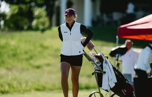 Emilie von Finckenstein walks her clubs to the next hole