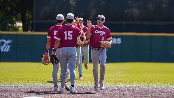 Reece Holbrook giving high-fives to teammates May 10, 2026 at Elon.