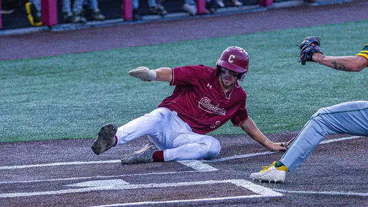 Jake Amman sliding into home plate May 15 vs William & Mary.