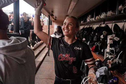 Bronwyn Conroy high fiving her teammates in the dugout