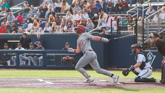 Ethan Plyler swinging a baseball bat at UNCW.