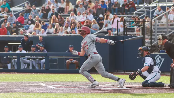 Ethan Plyler swinging a baseball bat at UNCW.