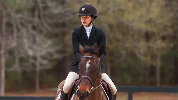 Senior Maggie Armes riding a horse.