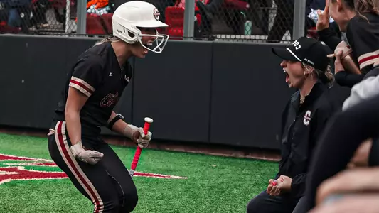 Bronwyn Conroy and Coach Mrowka celebrating in the dugout