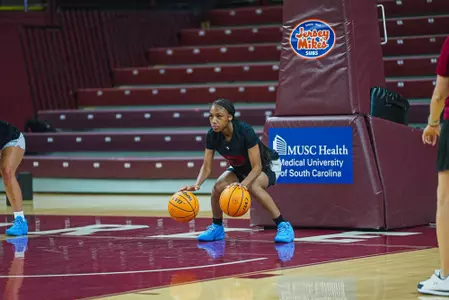 Dakara Merthie dribbles basketballs