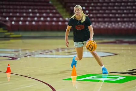 Maggie Spell dribbles basketball