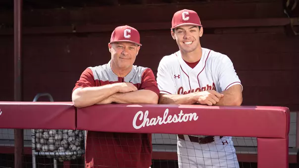 Chad and Reece Holbrook posing for a photo in the dugout at Patriots Point.