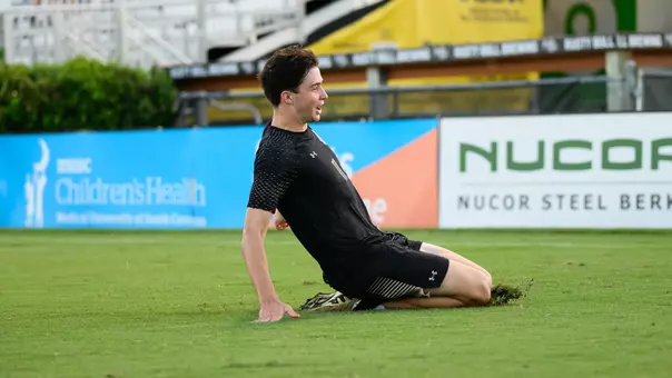 Matt Lenert slides across grass to celebrate goal
