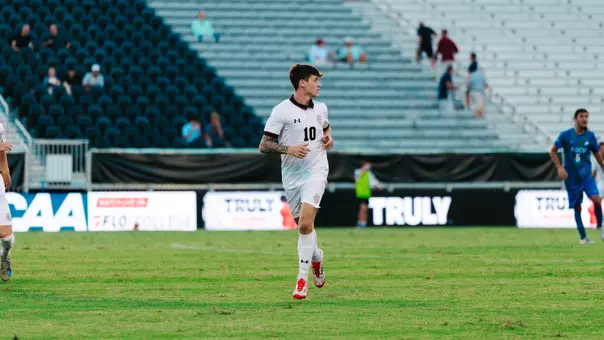 Lennon Gill runs across soccer field