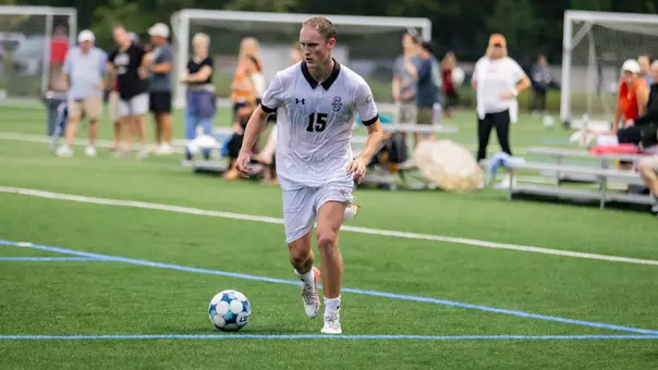Stian Bendvold dribbles soccer ball across pitch