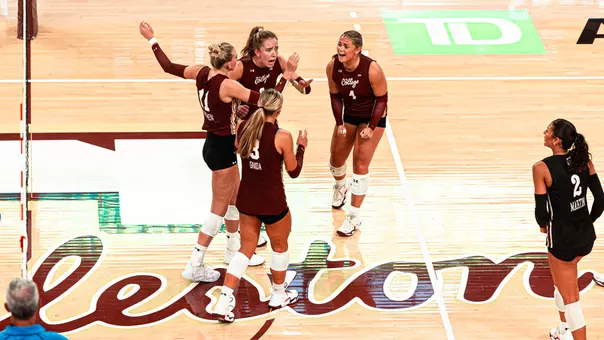Sydney Bates and Violet Poole celebrating with teammates.