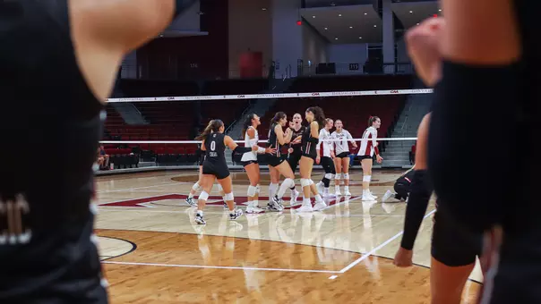 Charleston volleyball celebrating a 3-0 win at Elon Sept. 19.