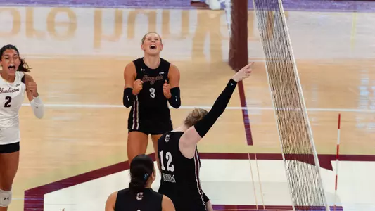 Julia Gnida and Caroline Noonan celebrating a Charleston point.