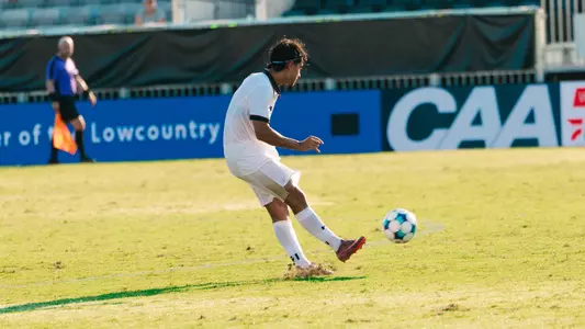 Federico Bellisi kicks soccer ball across pitch
