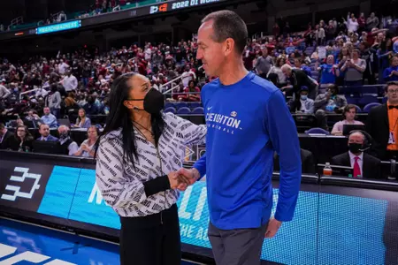 Coach Jim Flanery shakes hands with South Carolina's head coach, Dawn Staley, before their Elite Eight game of the 2022 NCAA Tournament.