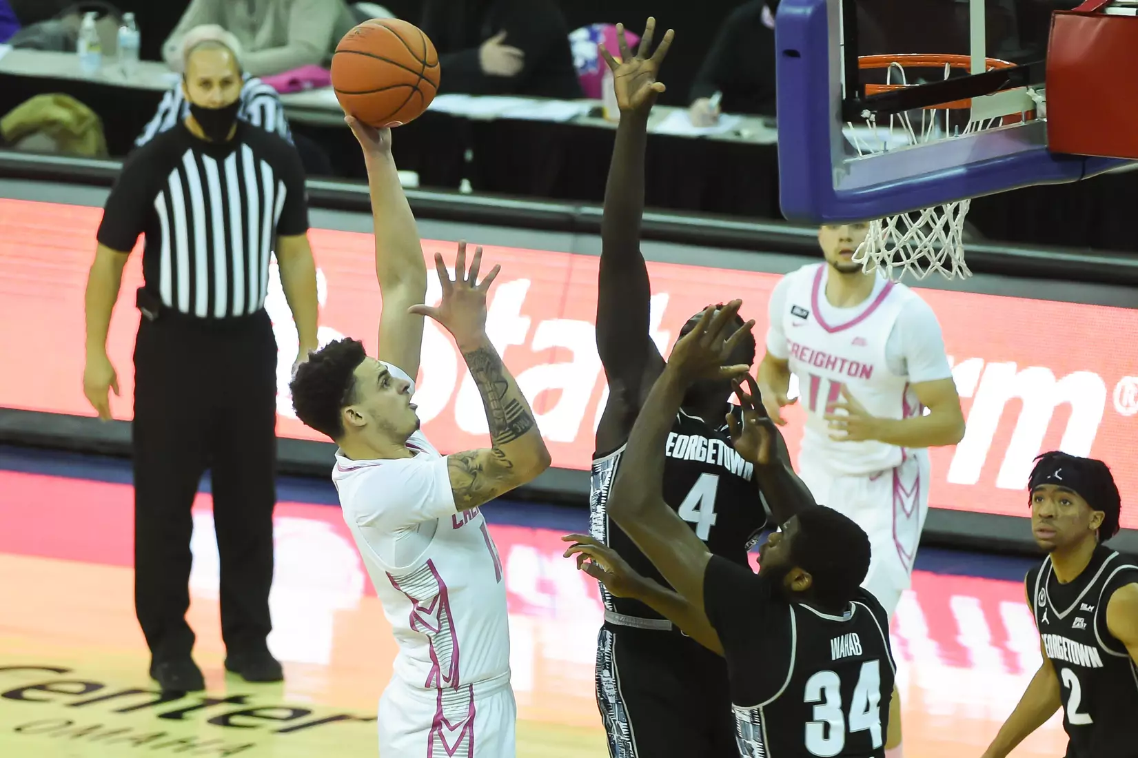 Feb 3, 2021; Omaha, Nebraska, USA; Creighton Bluejays forward Christian Bishop (13) shoots over Georgetown Hoyas forward Chudier Bile (4) and center Qudus Wahab (34) in the first half at CHI Health Center Omaha. Mandatory Credit: Steven Branscombe-USA TODAY Sports