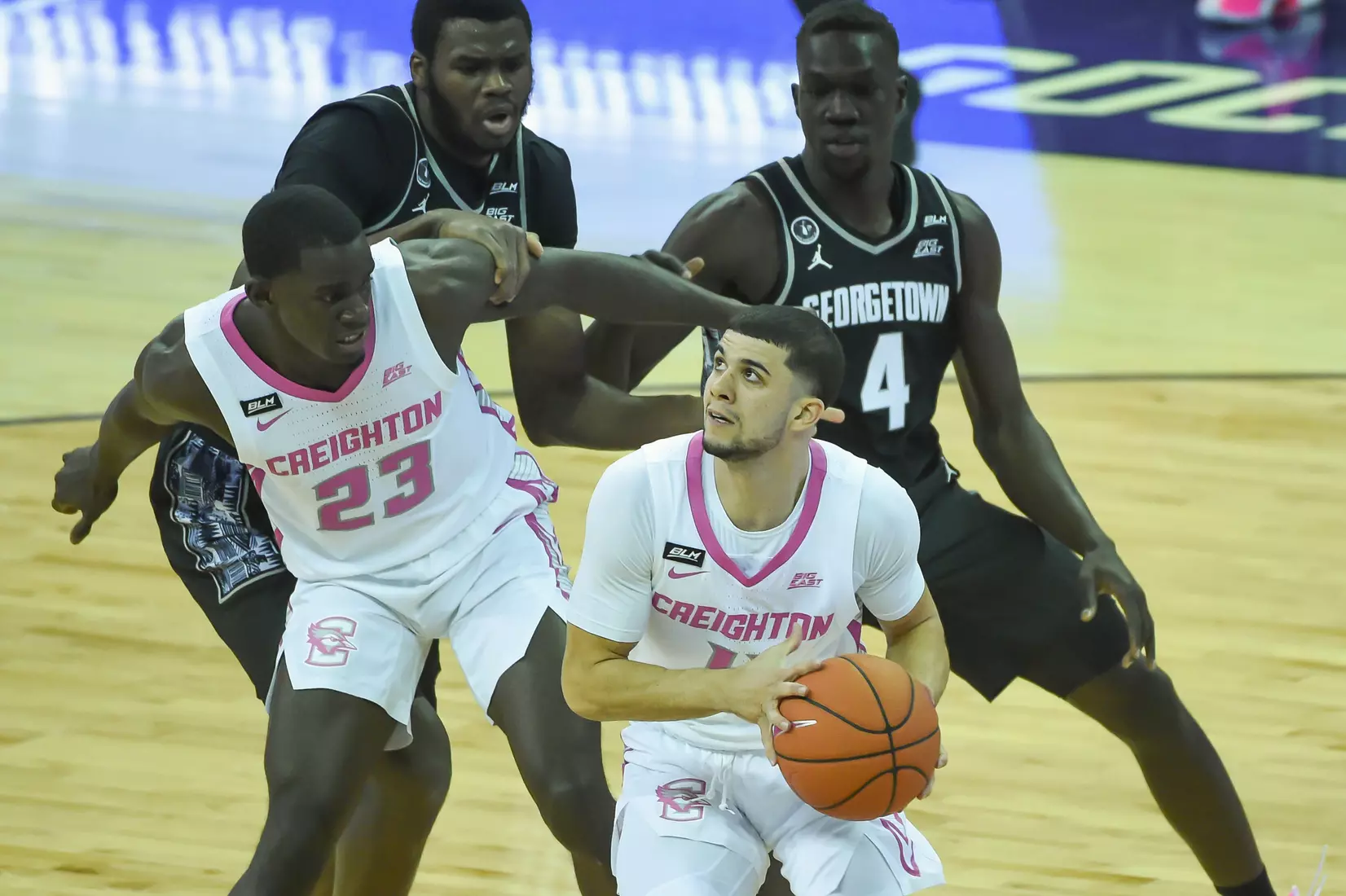 Feb 3, 2021; Omaha, Nebraska, USA; Creighton Bluejays guard Marcus Zegarowski (11) drives by Georgetown Hoyas forward Chudier Bile (4) in the first half at CHI Health Center Omaha. Mandatory Credit: Steven Branscombe-USA TODAY Sports