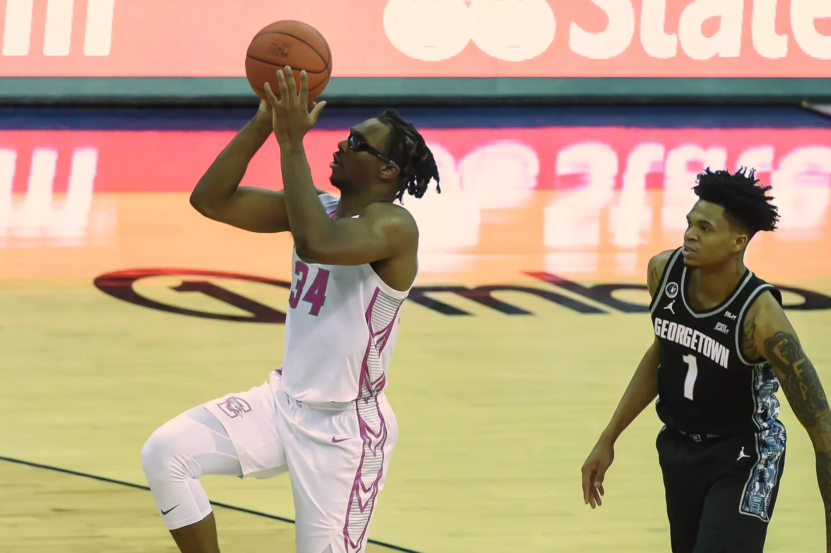 Feb 3, 2021; Omaha, Nebraska, USA; Creighton Bluejays guard Denzel Mahoney (34) scores against Georgetown Hoyas forward Jamorko Pickett (1) in the second half at CHI Health Center Omaha. Mandatory Credit: Steven Branscombe-USA TODAY Sports