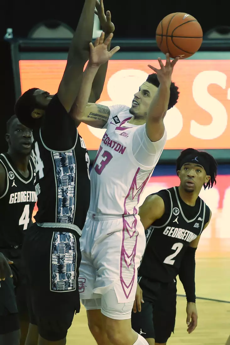 Feb 3, 2021; Omaha, Nebraska, USA; Creighton Bluejays guard Denzel Mahoney (34) attempts to score against Georgetown Hoyas center Qudus Wahab (34) in the second half at CHI Health Center Omaha. Mandatory Credit: Steven Branscombe-USA TODAY Sports