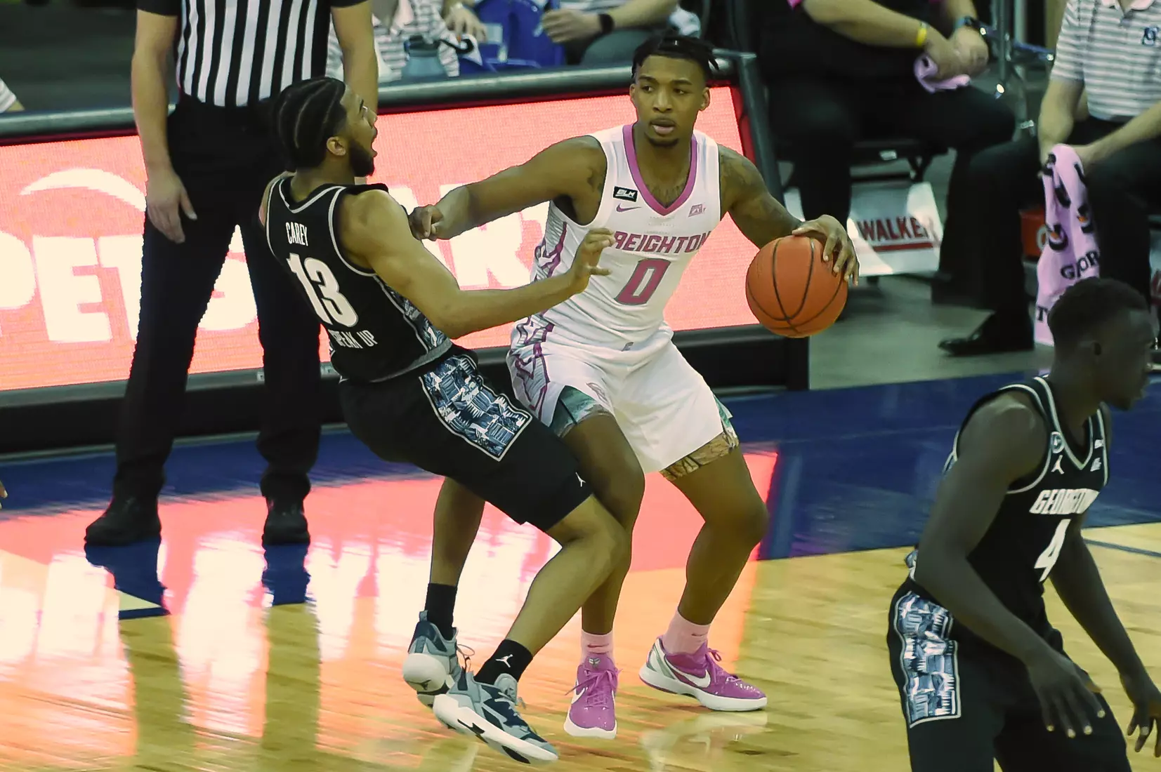 Feb 3, 2021; Omaha, Nebraska, USA; Georgetown Hoyas guard Donald Carey (13) takes a charge from Creighton Bluejays guard Antwann Jones (0) in the second half at CHI Health Center Omaha. Mandatory Credit: Steven Branscombe-USA TODAY Sports