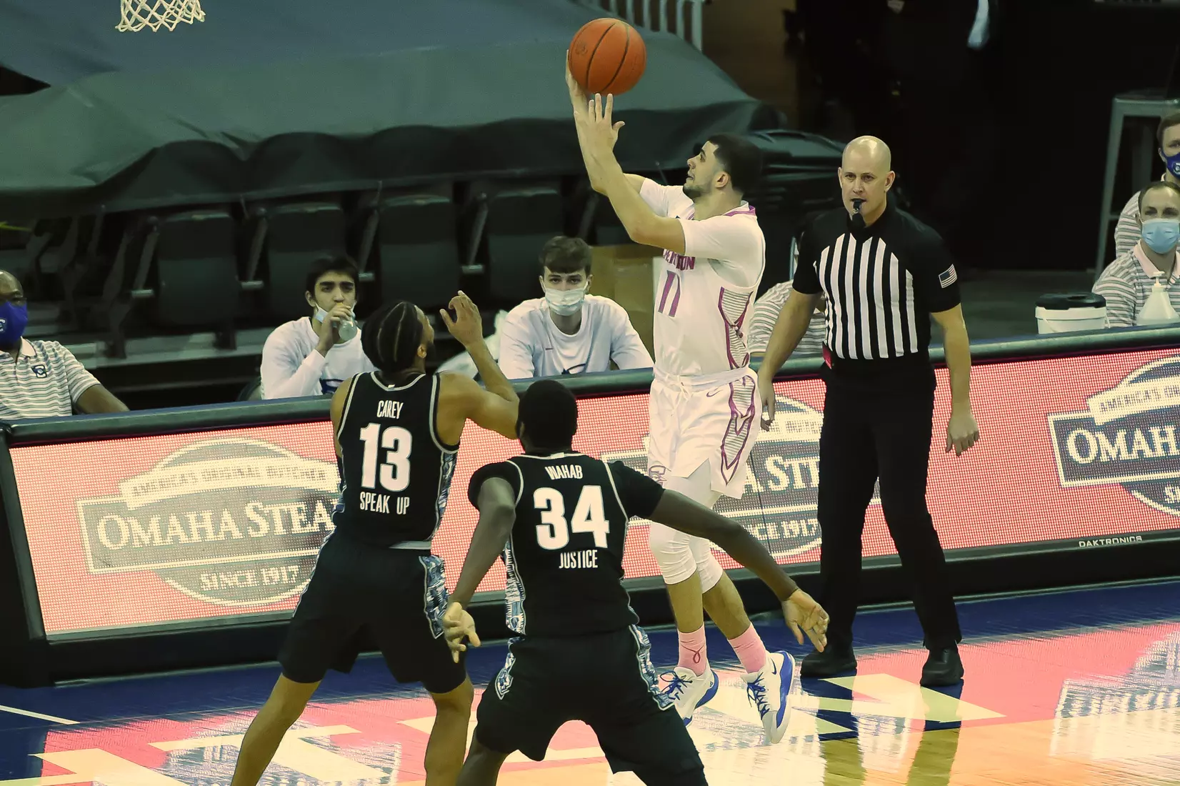 Feb 3, 2021; Omaha, Nebraska, USA; Creighton Bluejays guard Marcus Zegarowski (11) drives against Georgetown Hoyas guard Donald Carey (13) and center Qudus Wahab (34) in the second half at CHI Health Center Omaha. Mandatory Credit: Steven Branscombe-USA TODAY Sports